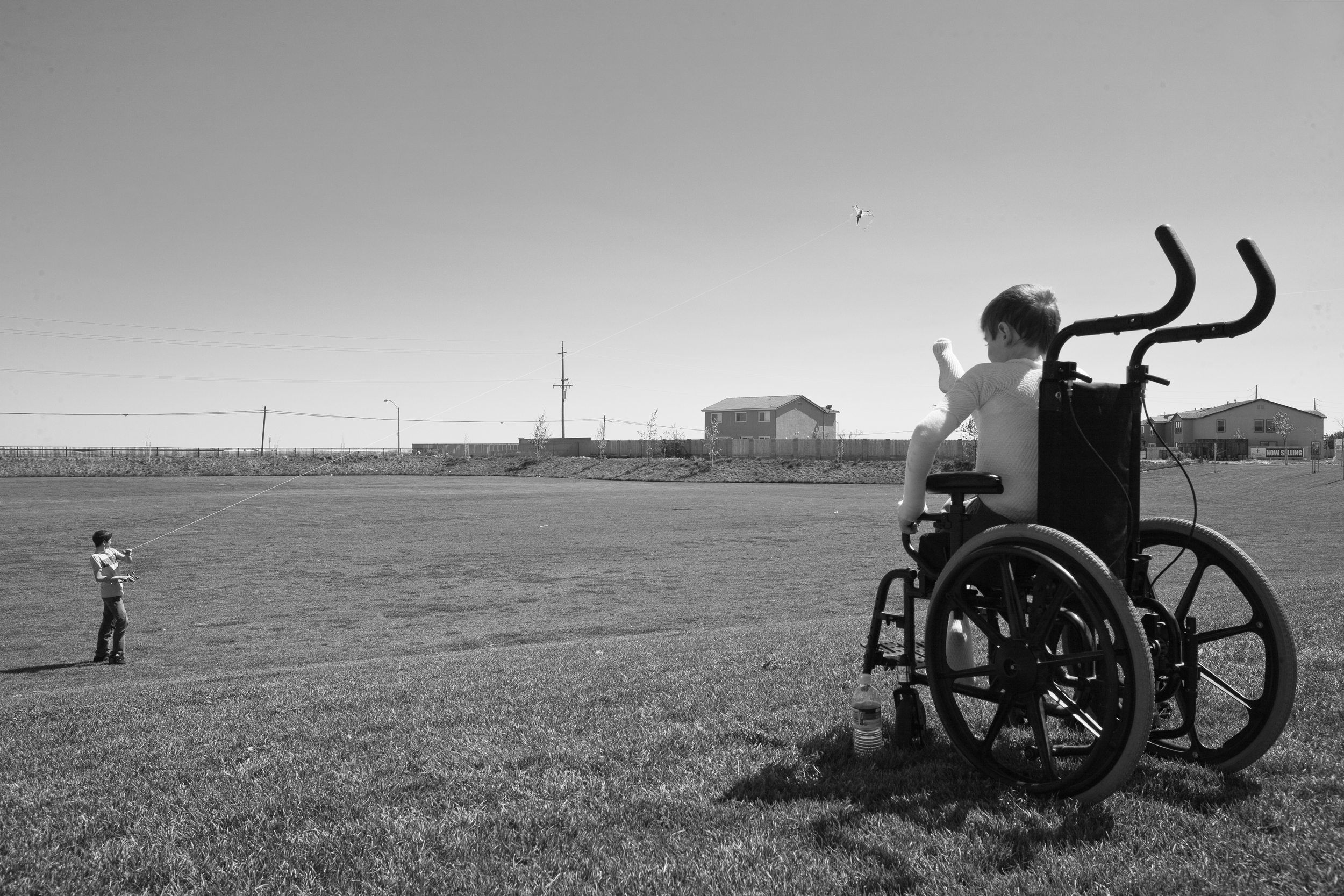  Garrett Spaulding, 12, born with Epidermolysis watchesfrom his wheel chair as his brother David flies a kite on a windy afternoon. Garrett doesn’t have the strength to control the kite himself in a strong wind, nor does he like the feel of it in his