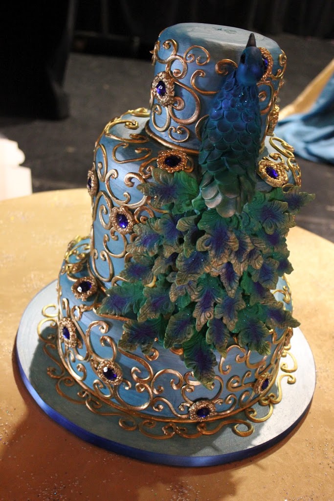 This sugar peacock cake was assembled from hand painted and hand cut sugar tail feathers.