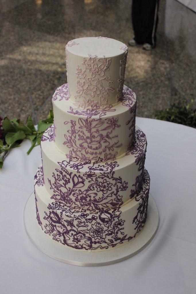 This cake was iced in buttercream with ombre piped buttercream lace inspired from the bride's dress. 