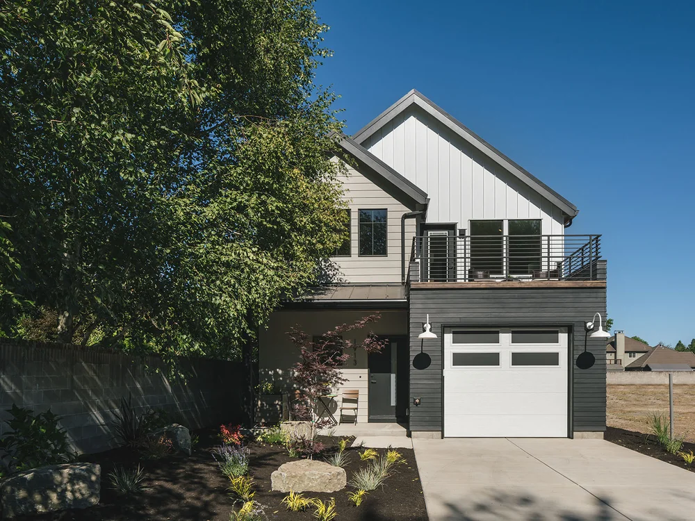 A modern farmhouse-style home with a balcony in Eugene