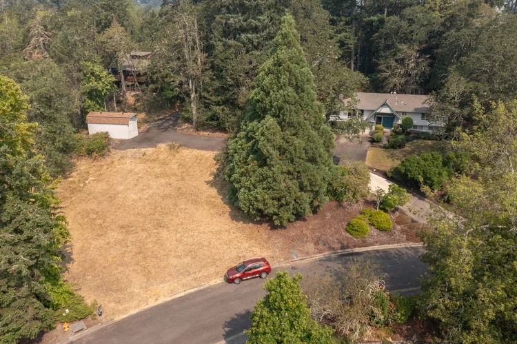 An adjoining lot among the trees at Normandy Way