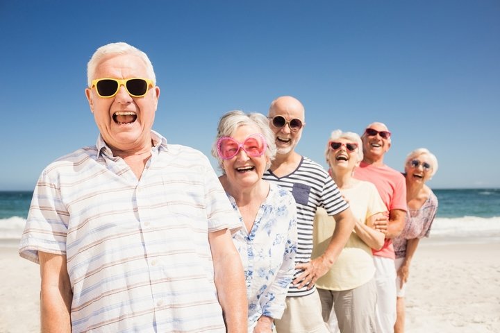 Seniors-Happy-Wearing-Sunglasses-On-Beach.jpg