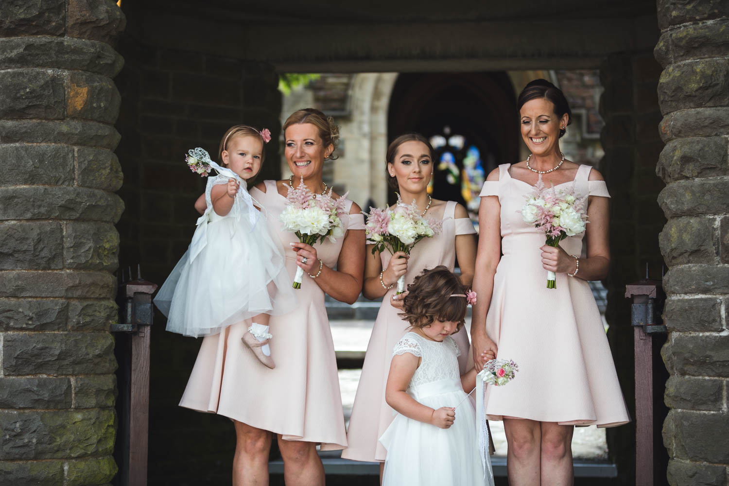 bridesmaids waiting by St Martins church Caerphilly with south wales wedding photographer