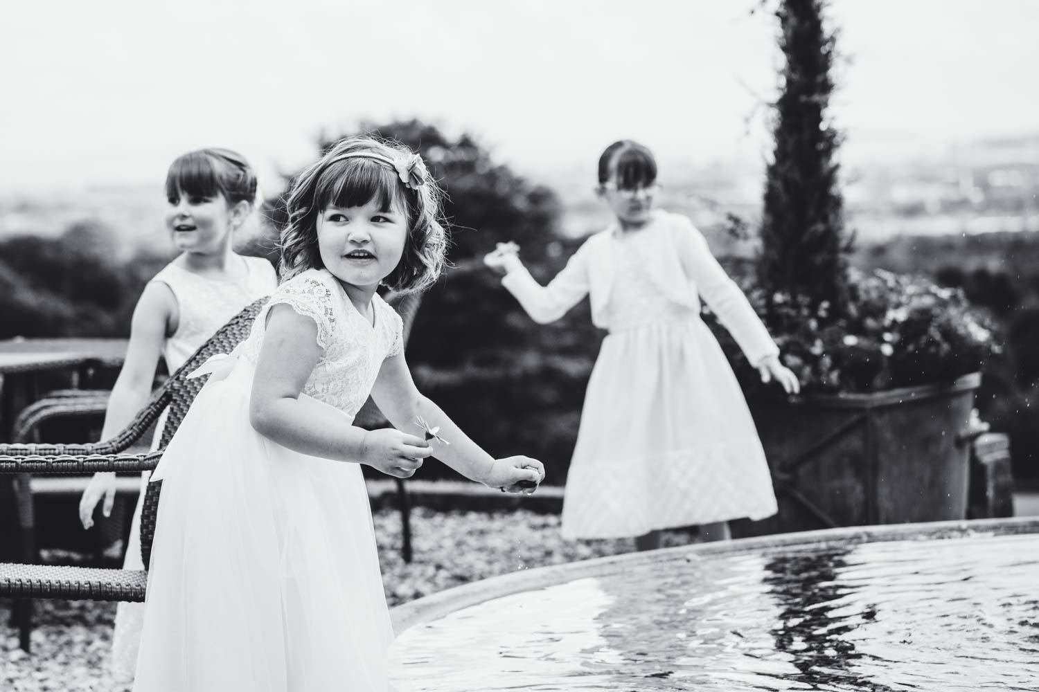 Children playing in the fountain at The New House Country Hotel, Thornhill, Cardiff with South Wales wedding photographer