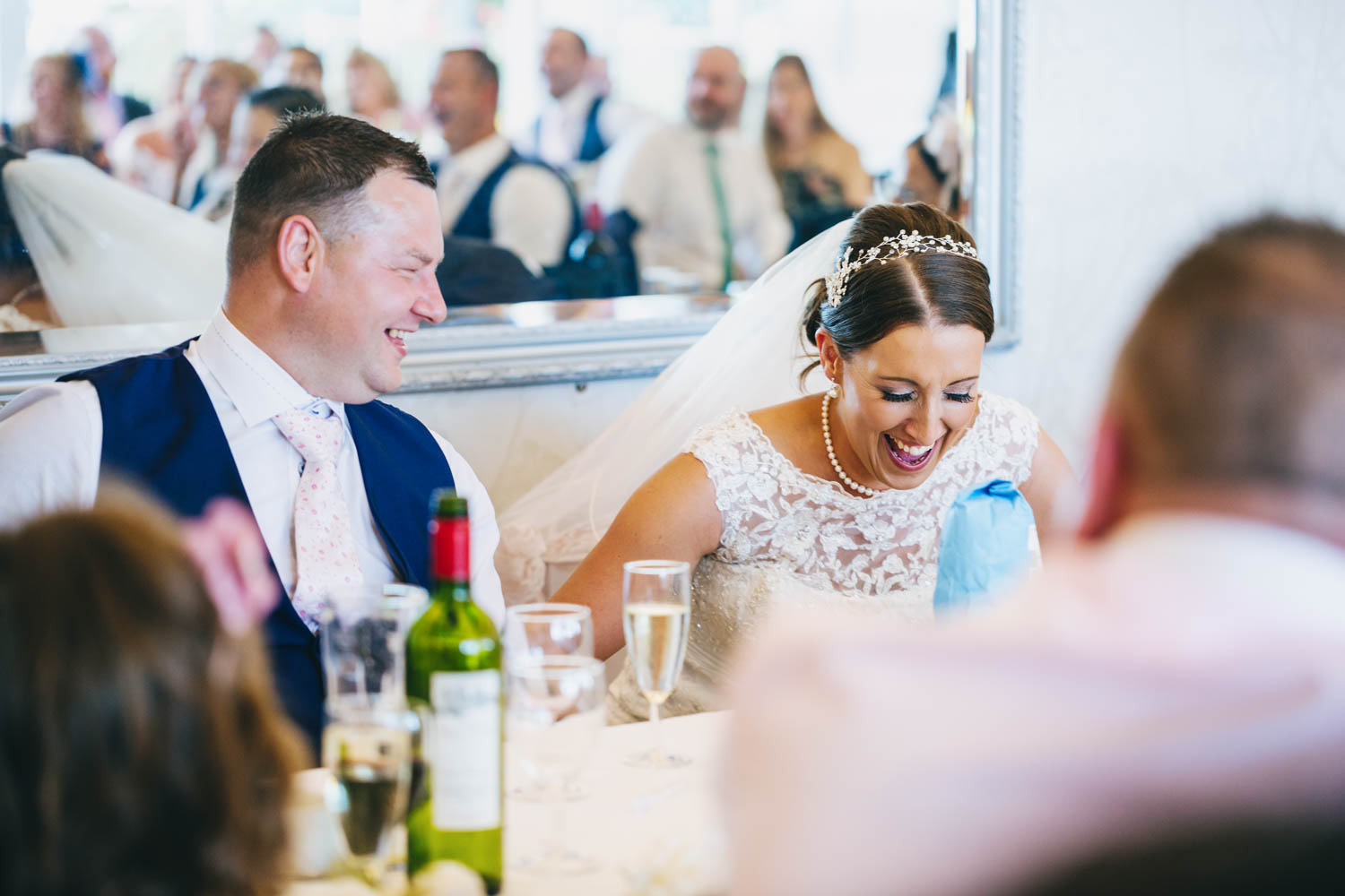 bride laughing at funny speeches at The New House Country Hotel, Thornhill, Cardiff with south wales wedding photographer
