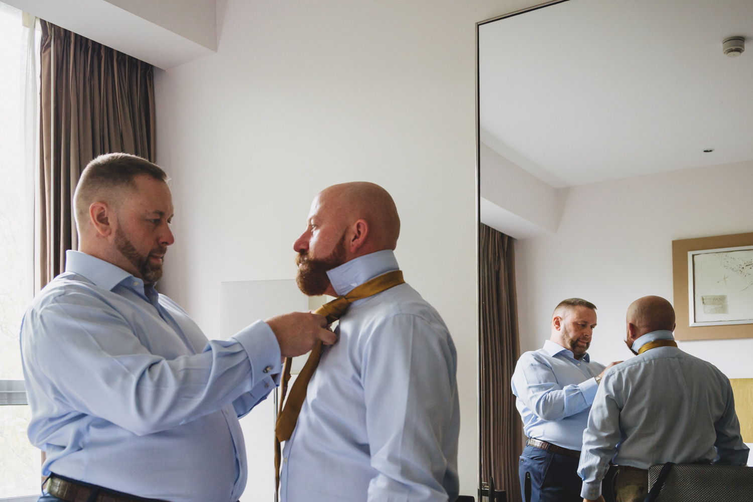 groom prep together for our gay wedding at park plaza hotel and cardiff city hall with gay friendly south wales wedding photographer