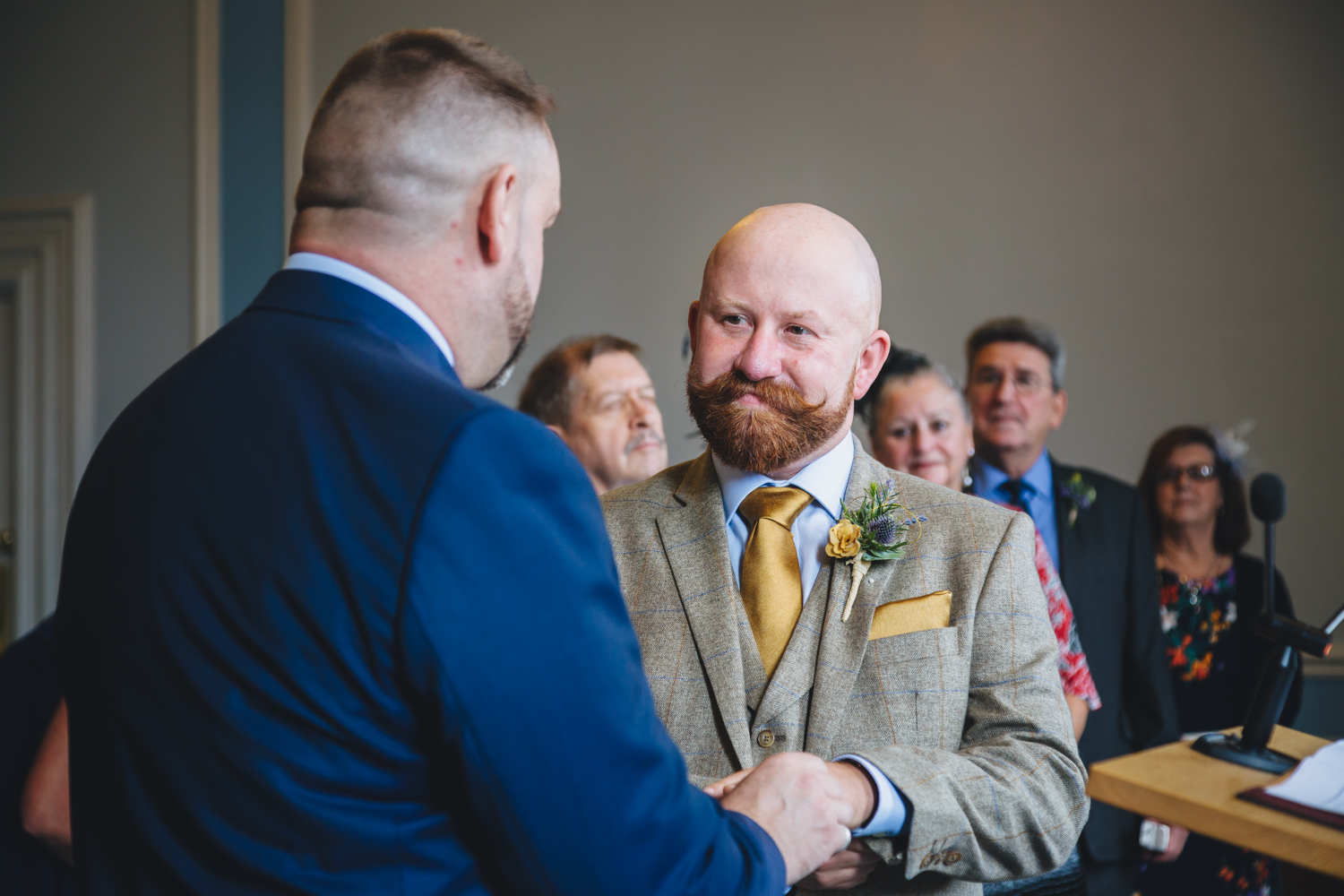 exchanging vows gay wedding ceremony at cardiff city hall with gay friendly south wales wedding photographer