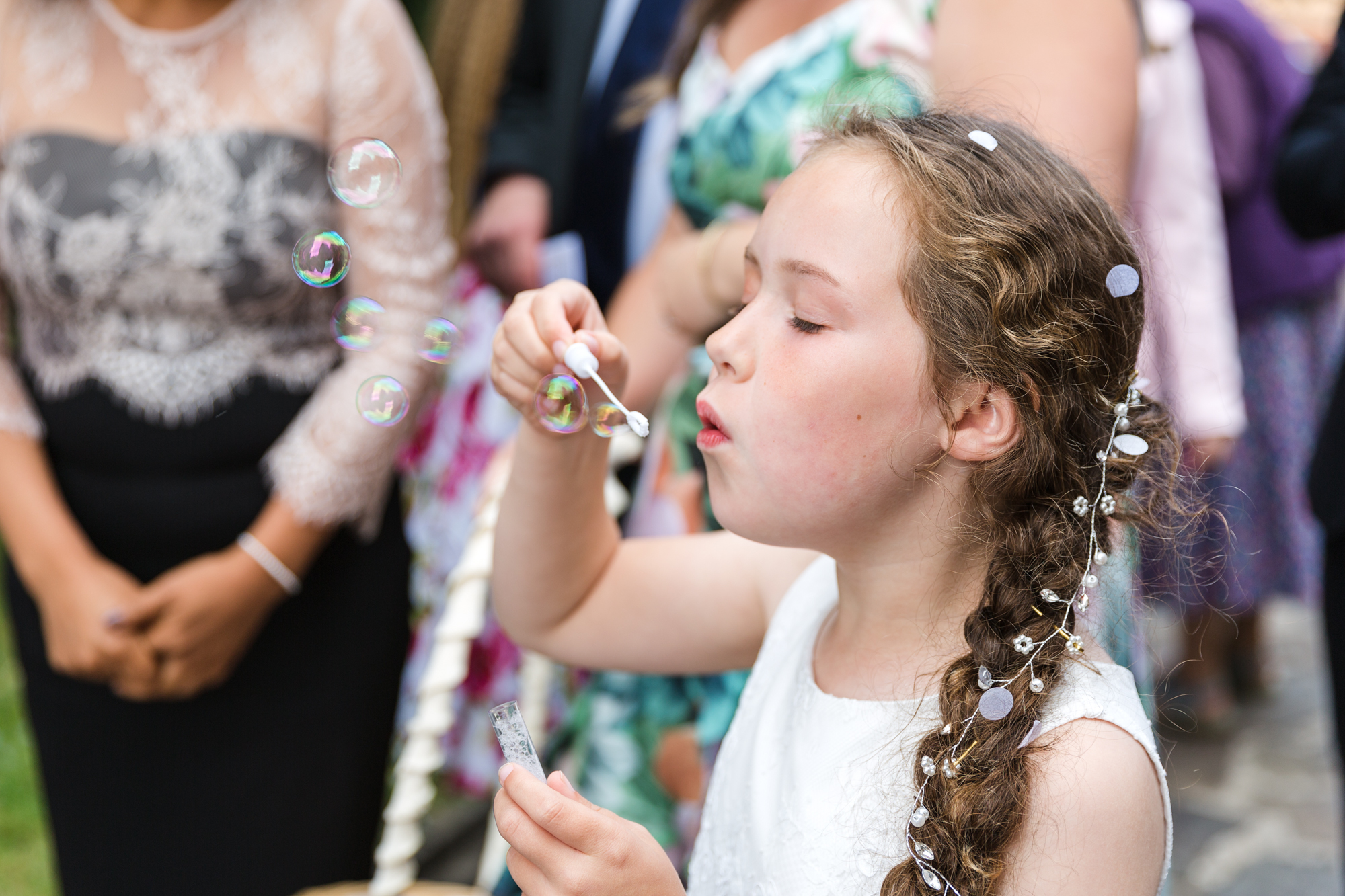 bridesmaid blowing bubbles outside St Martins Church, Caerphilly