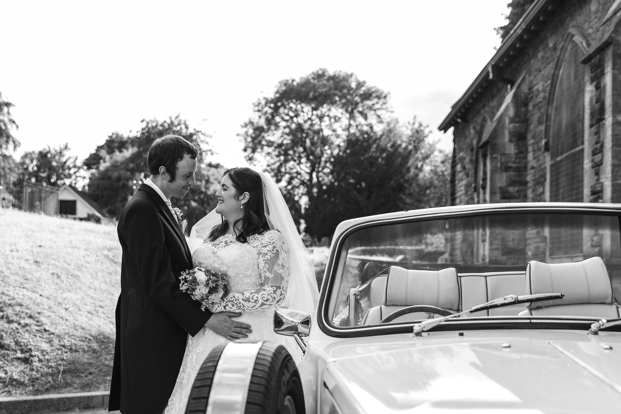 bride and groom with wedding car outside St Martins Church, Caerphilly