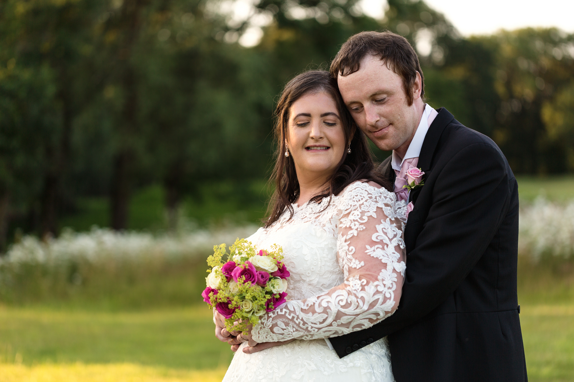Bride and groom portraits in golden light at Ridgeway Golf club, Caerphilly mountain