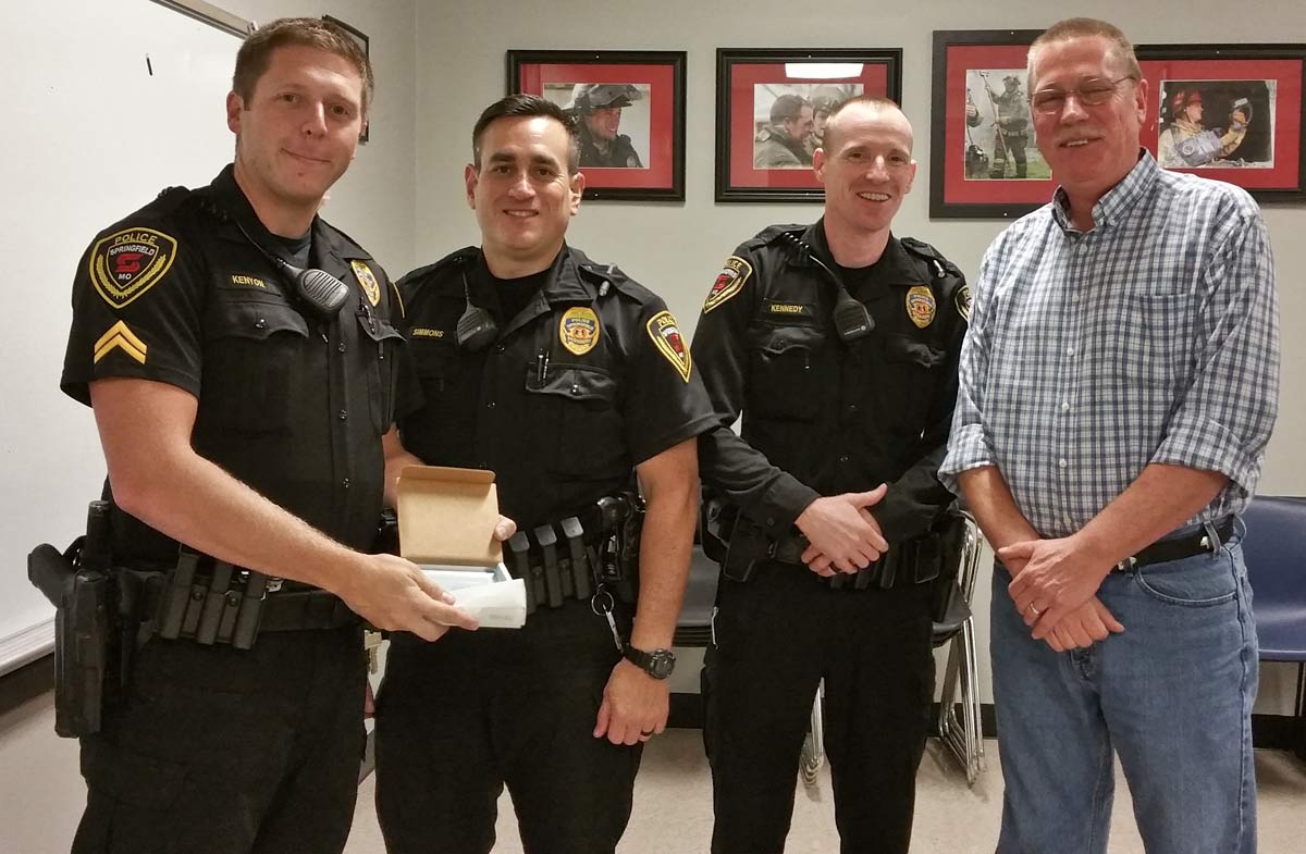 Corporal David Kenyon along with Officers Daniel Simmons and Sean Kennedy of the Springfield Police Department, are recognized by President of Phelps Grove Association, Eric Pauly