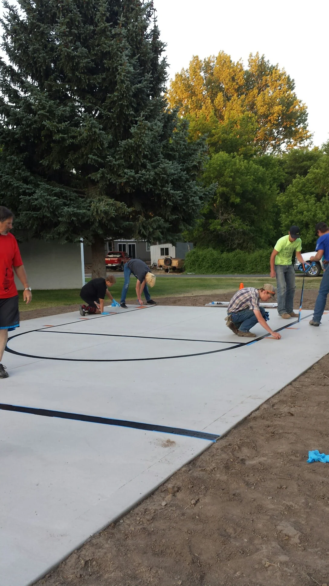 The Albion Scouts helped with nearly every step of the process and here they are adding the lines to the new court.