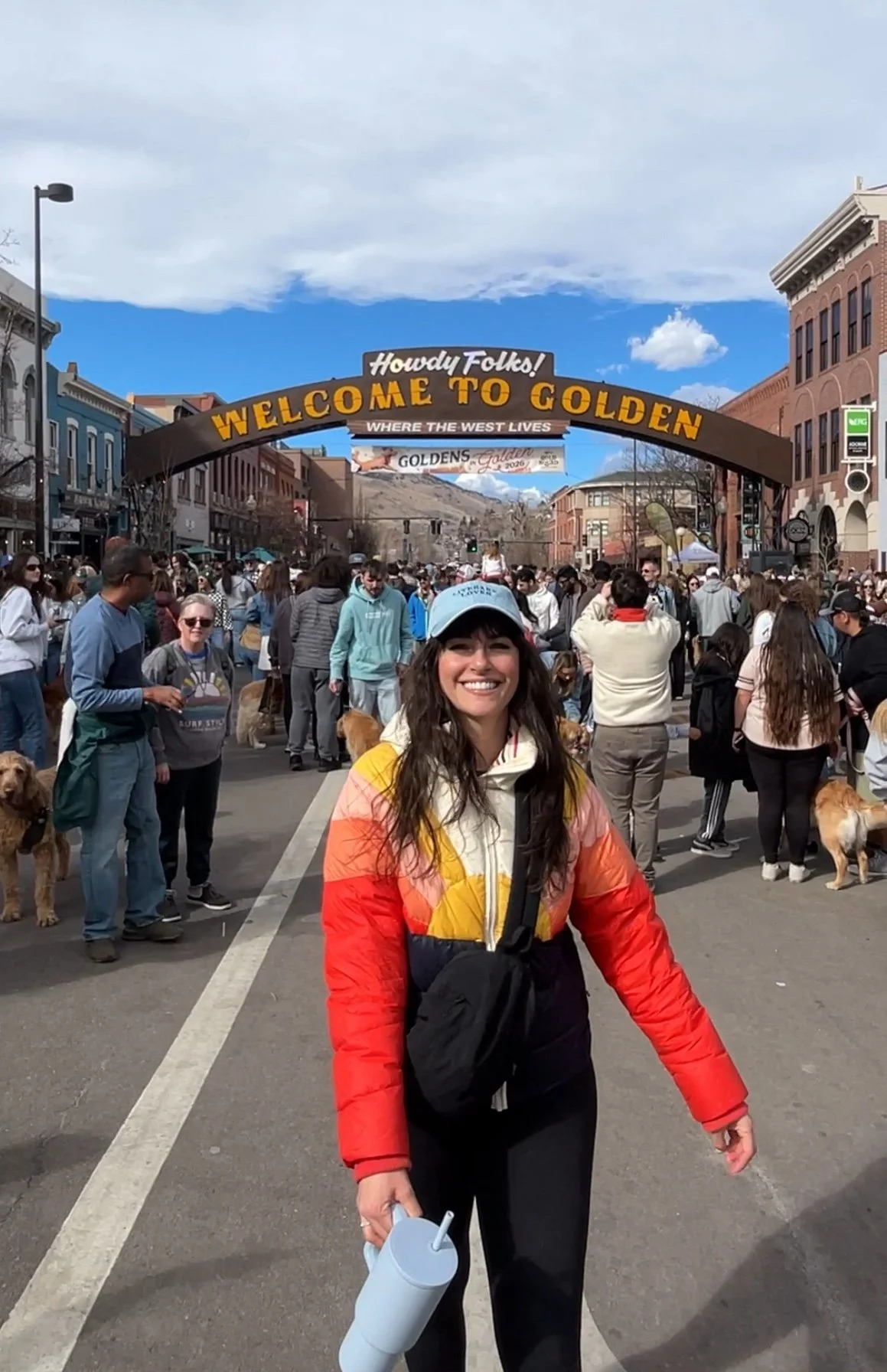 Denver content creator Carly Henderson stands in front of the "Welcome to Golden" sign at the Goldens in Golden event in 2026.