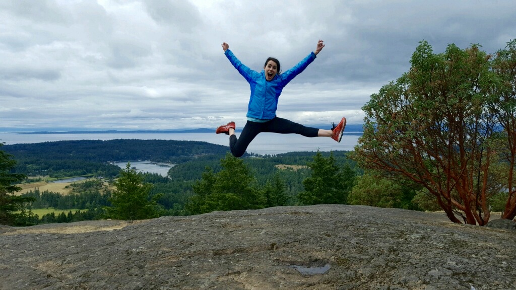 Jumping for joy on the top of Mt. Young, San Juan Island, WA.
