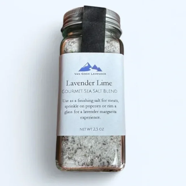 A jar of Lavender Lime gourmet sea salt blend with a white label and silver lid, placed on a white background.