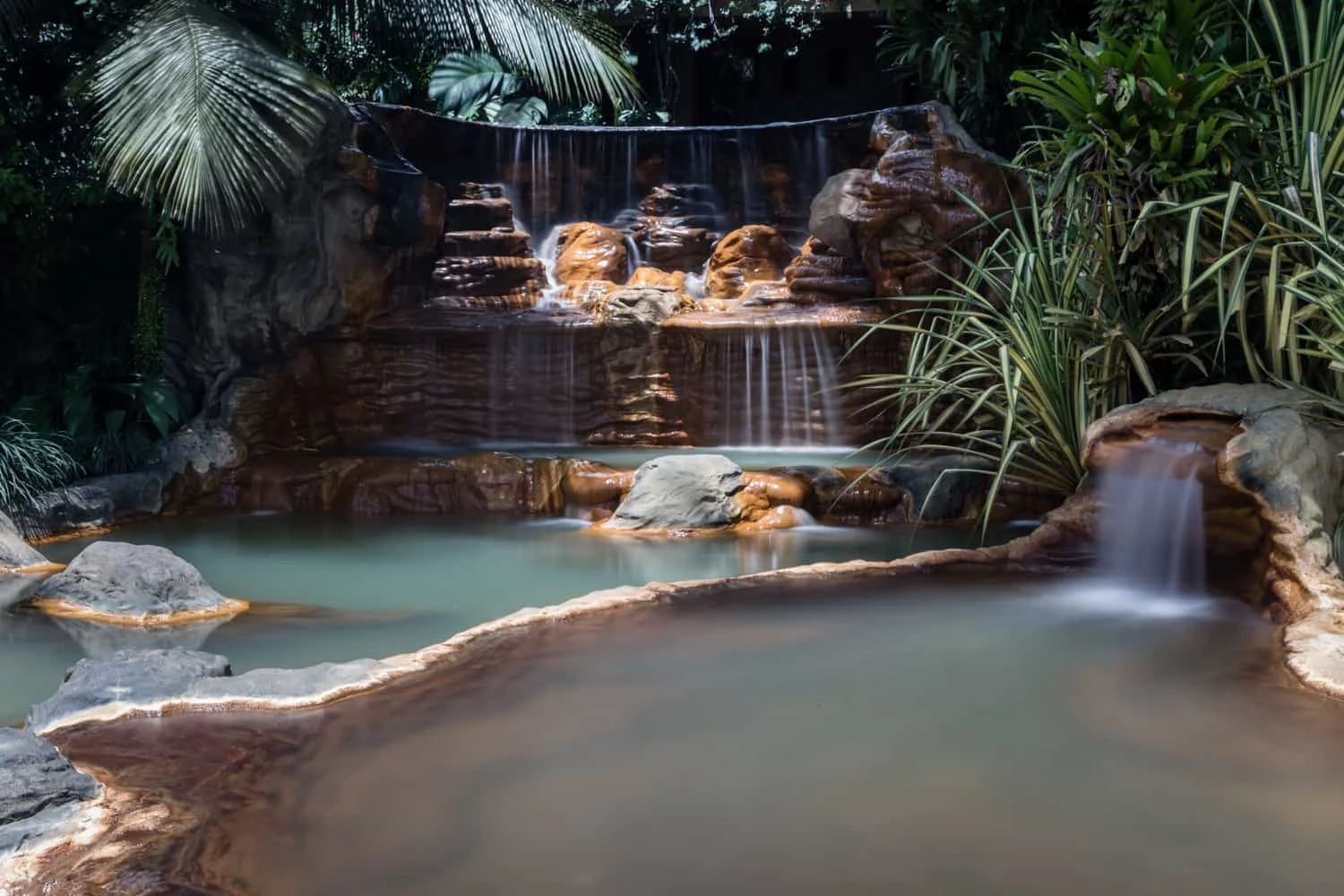 Cascading waterfalls in one of the many thermal pools at The Springs Resort & Spa in Costa Rica.