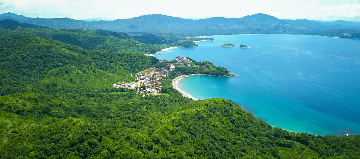 Arial view of the town of Las Catalinas surrounded by rainforest next to gorgeous Pacific-Coast beaches.