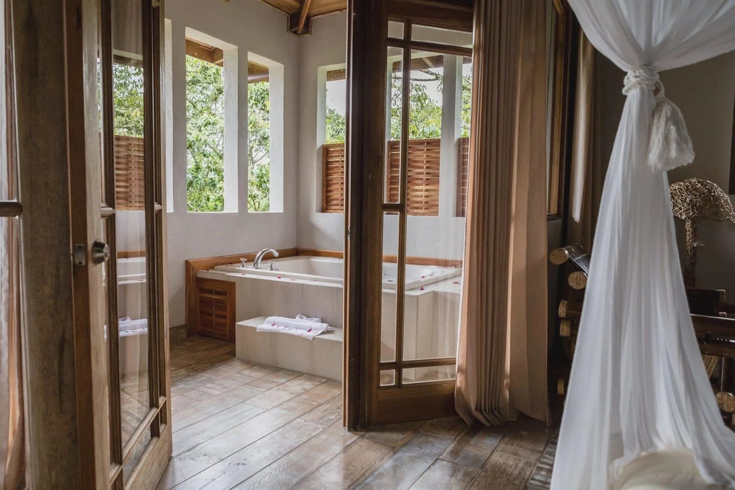 This honeymoon suite at Lost Iguana Resort & Spa in La Fortuna has French doors that lead to an outside jacuzzi-type tub that has a magnificent view of the Arenal Volcano.