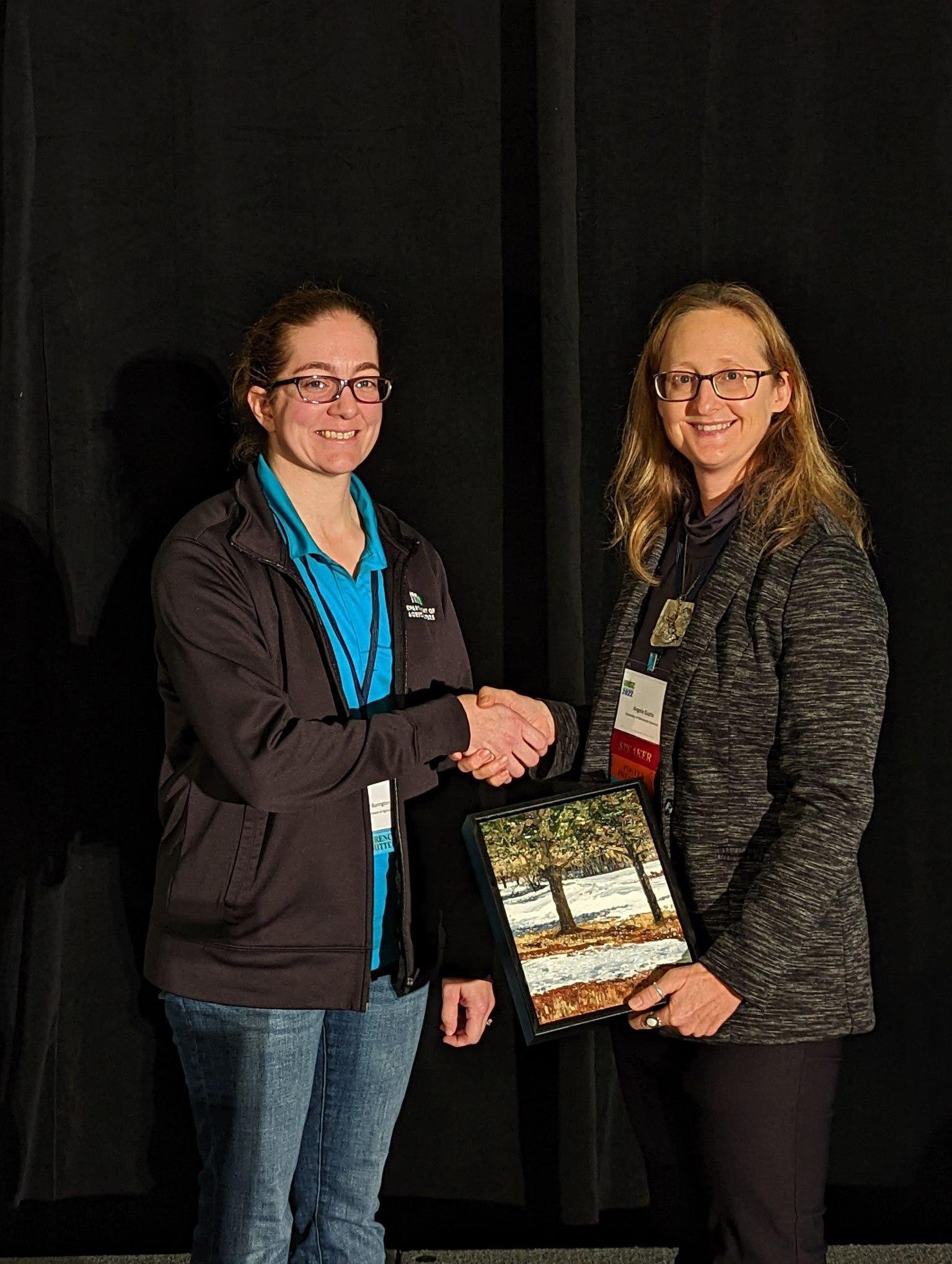 Angela Gupta accepts the Team Achievement Award on behalf of the Sisters of Saint Francis - Environmental Committee