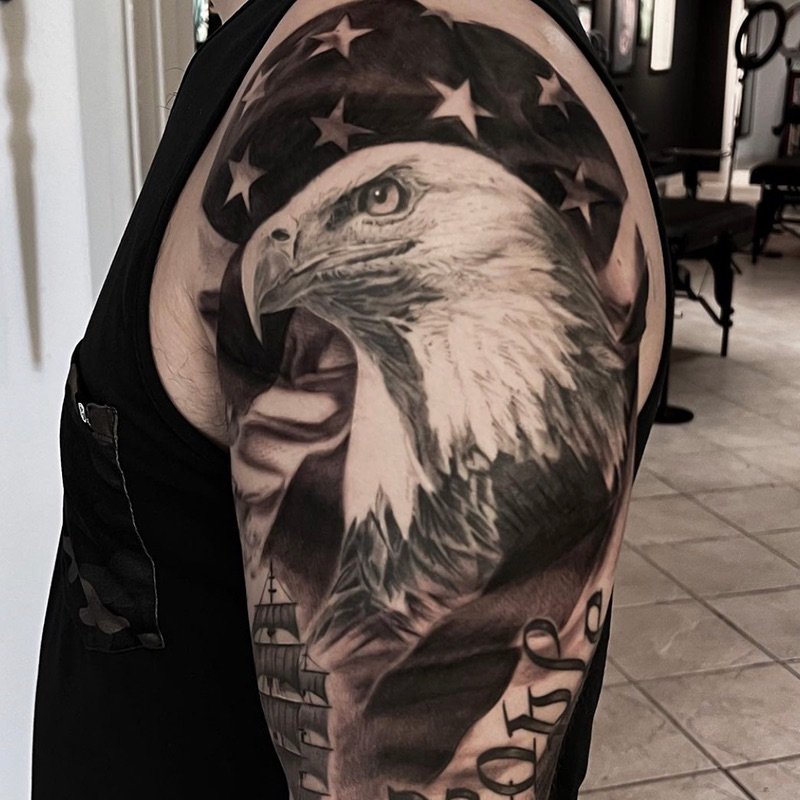 John Millan Black and Grey Arm Tattoo