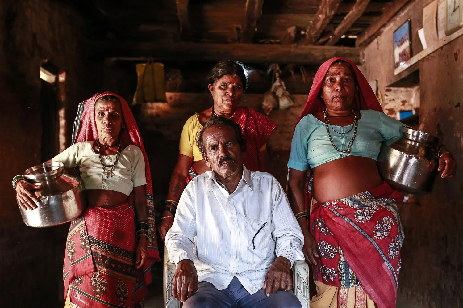 Sakharam Bhagat poses with his wives, Sakhri, Tuki and Bhaagi (L to R) inside their house.