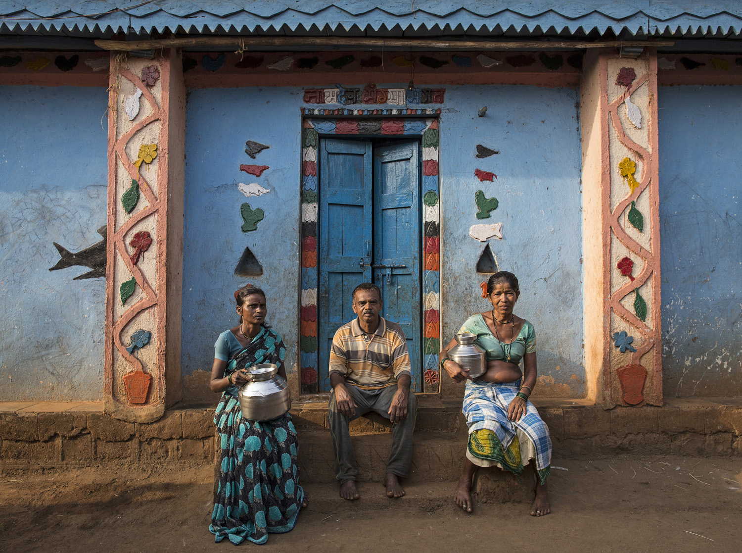  Namdeo poses with his wives Shivarti (L) and Bagabai (R) outside their house in Denganmal village. 