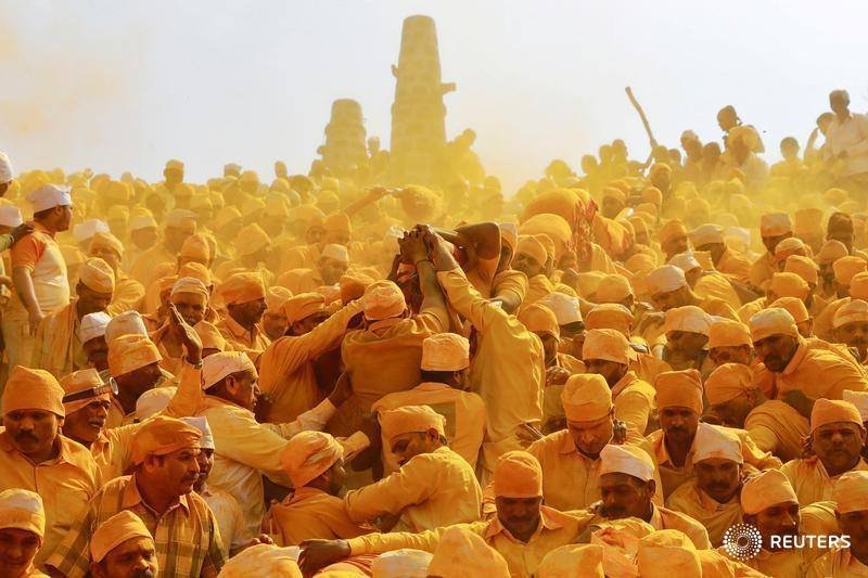 Feb 2019 Devotees throw turmeric powder as an offering to the shepherd god Khandoba as others carry a palanquin during 'Somvati Amavasya' at a temple in Jejuri, India..jpg