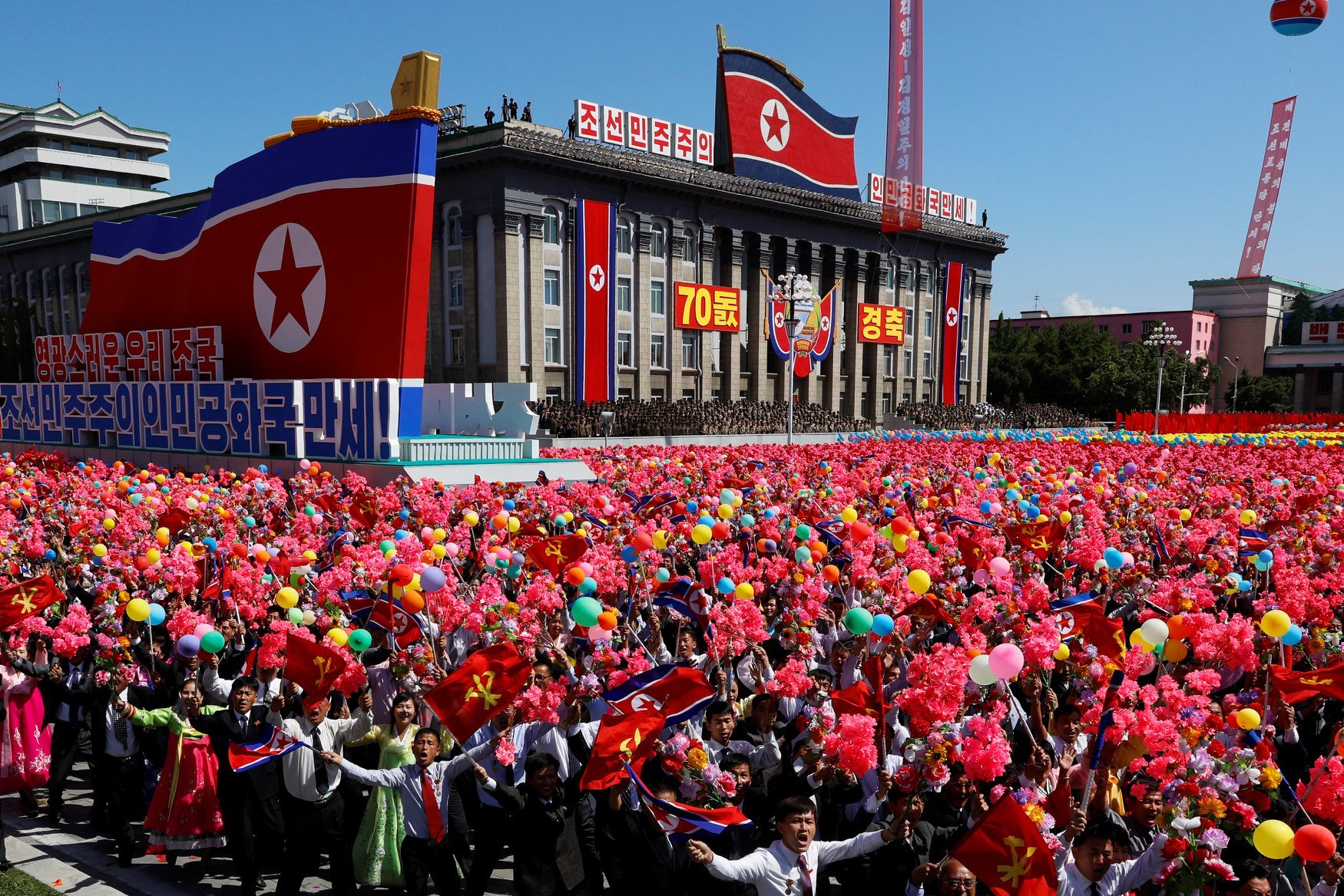 September 2018 People wave flowers and balloons during a military parade marking the 70th anniversary of North Korea's foundation in Pyongyang..jpg
