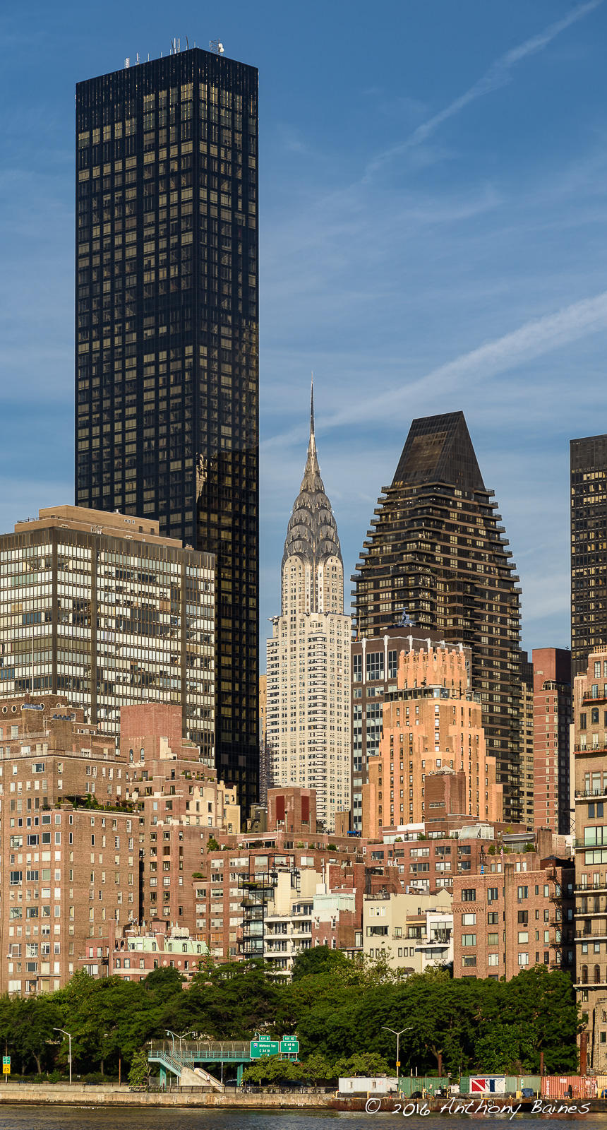 The Chrysler Building peeps through closer buildings