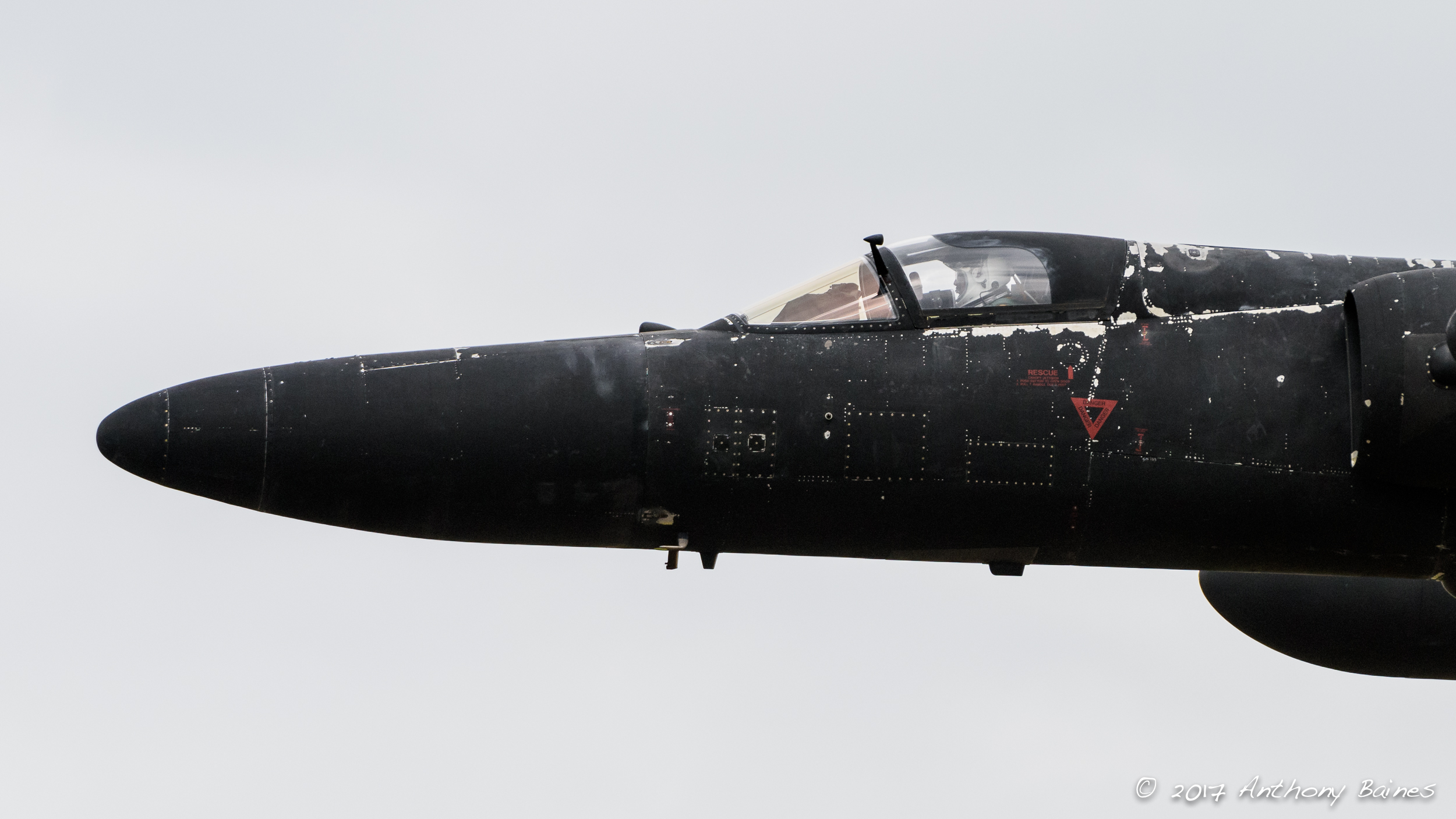Cockpit and nose of a U-2. Notice that the p ilot wears a pressure helmet (essentially part of a complete space suit). I'm not sure whether the white marks , particularly around the cockpit, are chipped paintwork, or residual ice that has condensed in high altidtude flight.