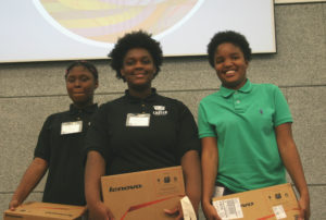 Ajah and Naomi from the Carter School of Excellence proudly stand beside "earit," the winning design for the Chicago Maker's challenge!