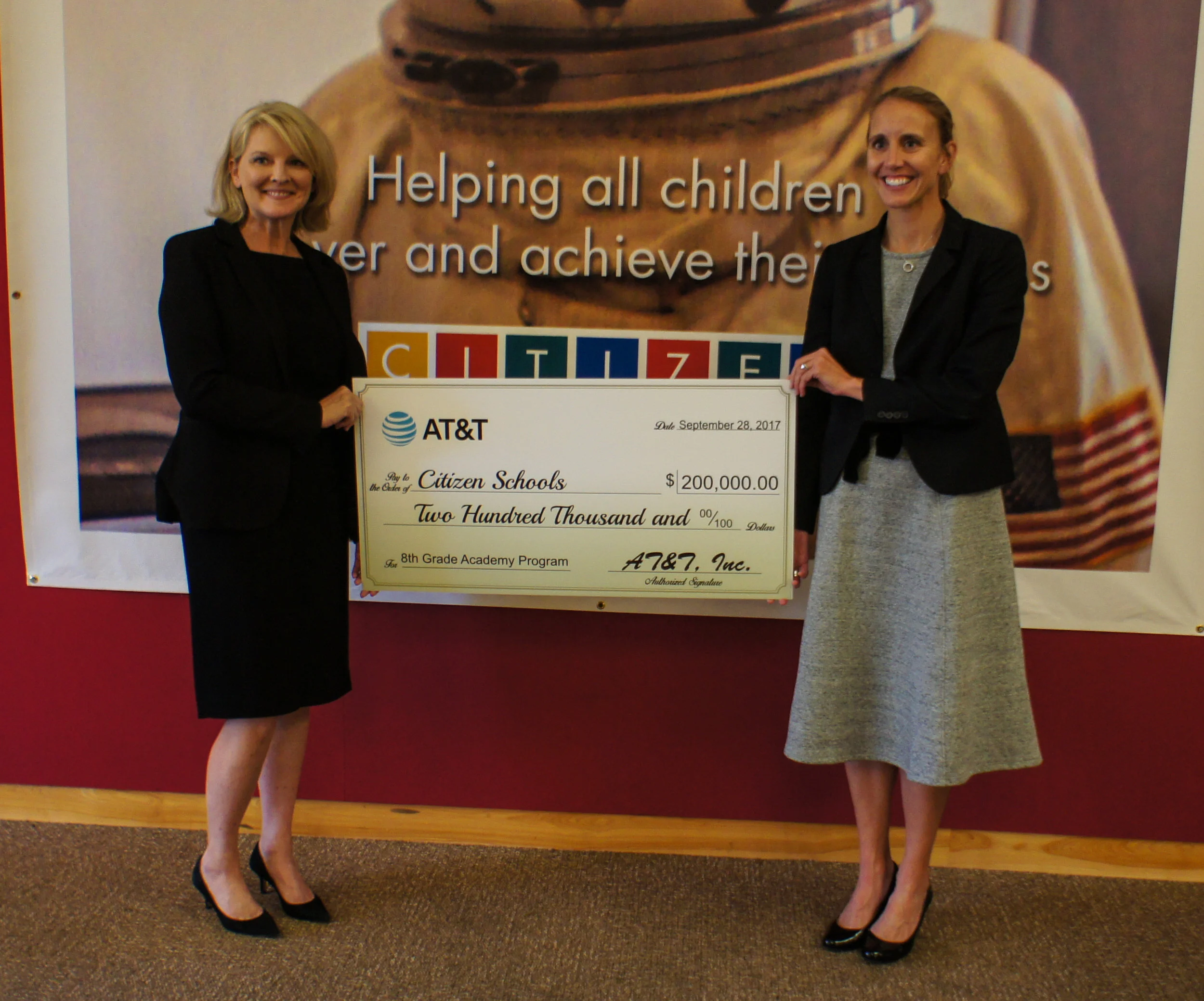 Patty Jacobs, President of AT&T New England, presents Citizen Schools CEO Em McCann with AT&T Aspire’s $200,000 grant award