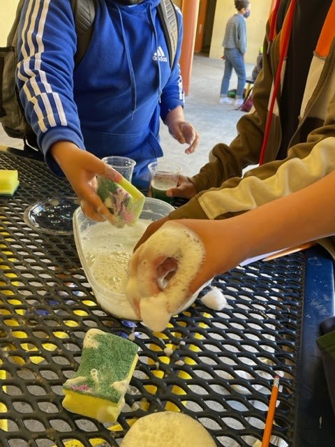 Students work on a hands-on activity to learn about oil spills.
