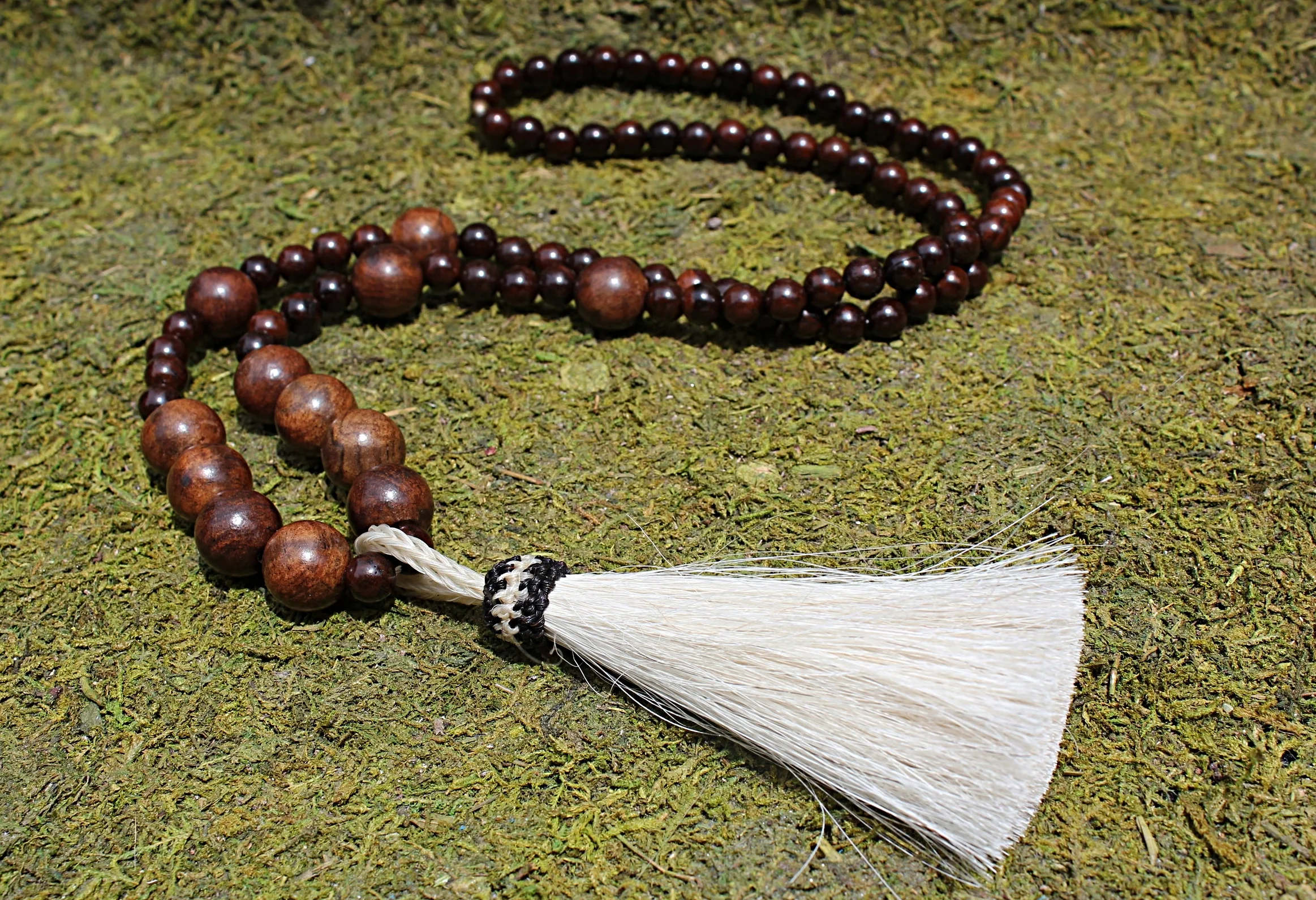 White Horsehair Tassel on Driftwood 