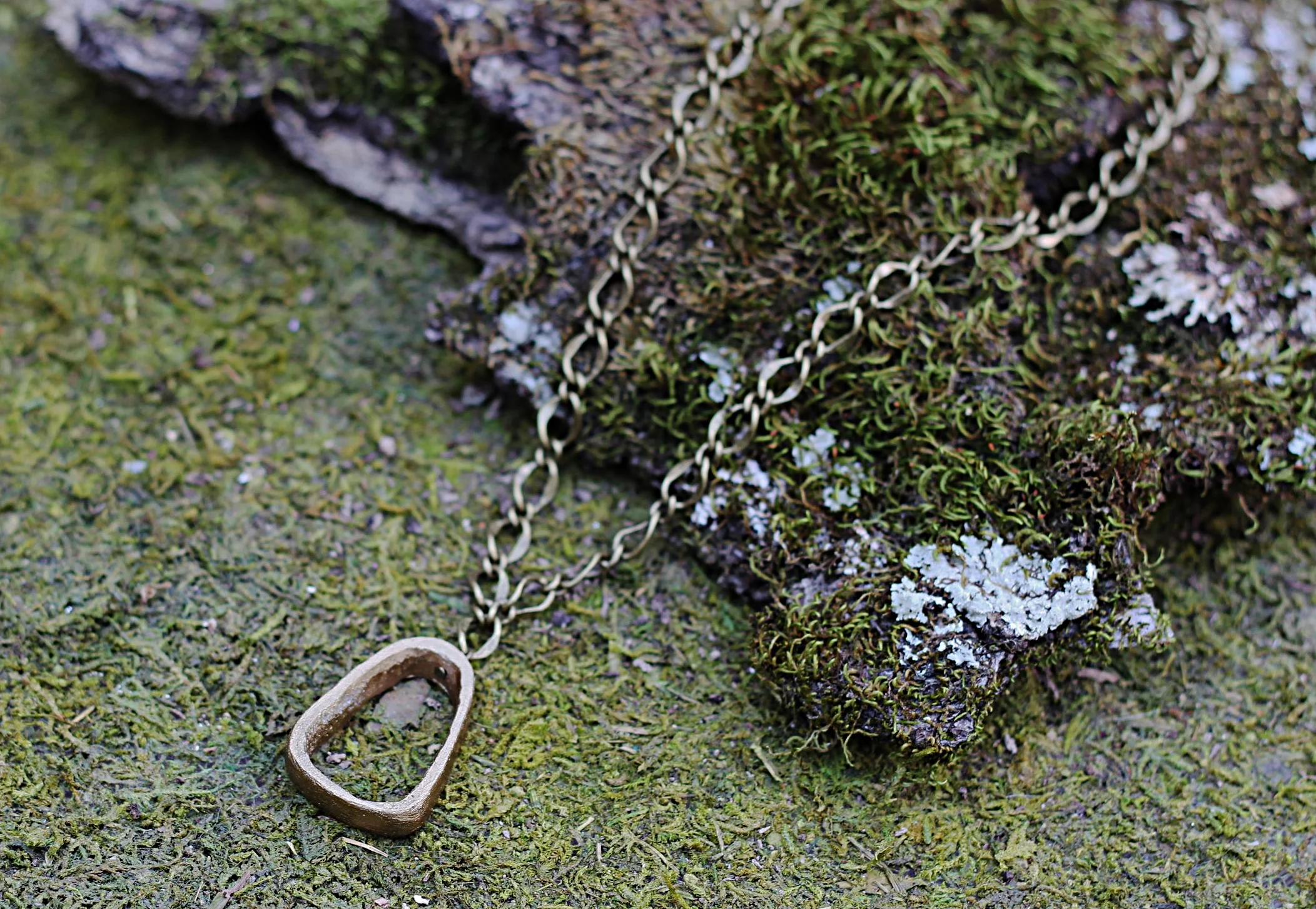 Gold Dipped Oval Bone Piece on Antiqued Gold Tone Chain