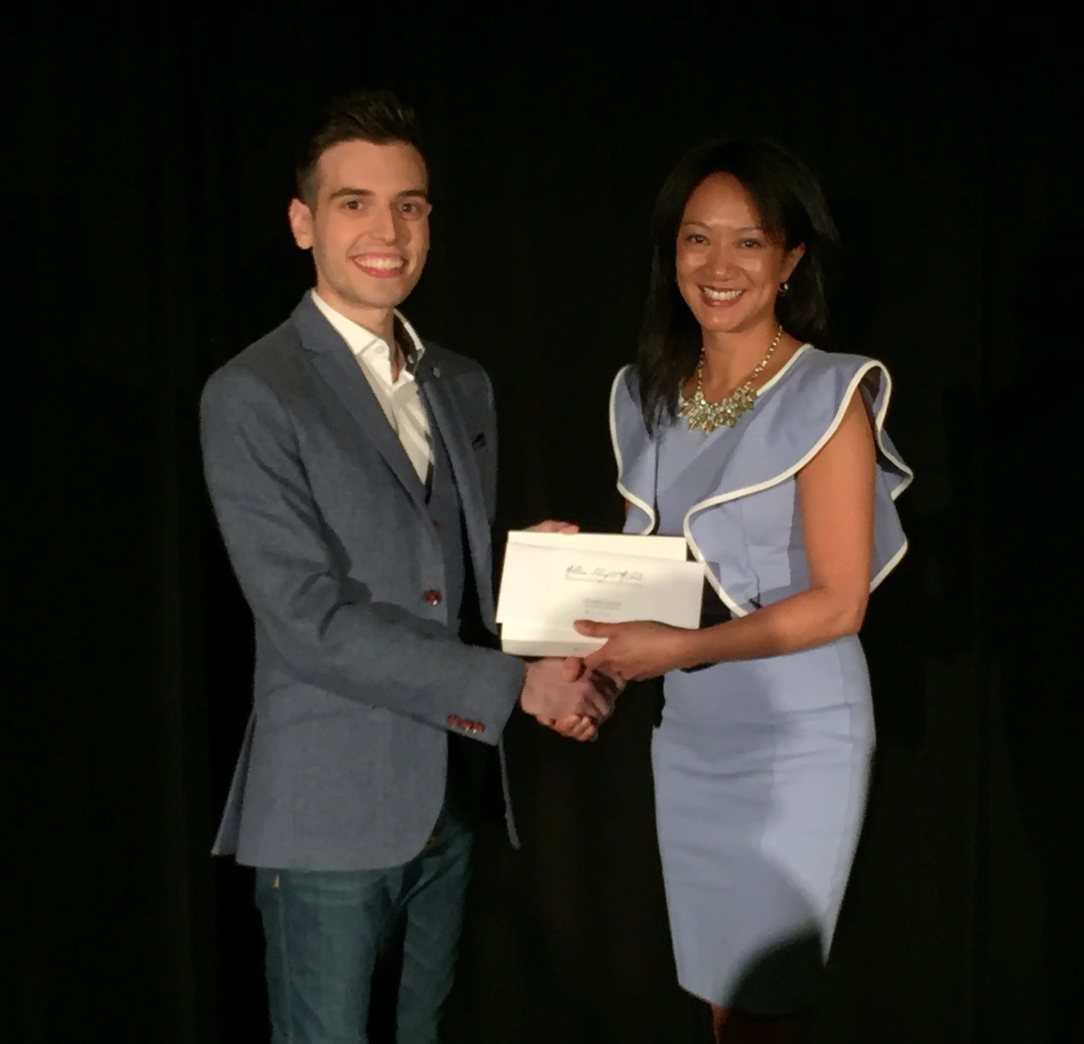 Receiving the award from Julie Eng, Magicana Executive Director.