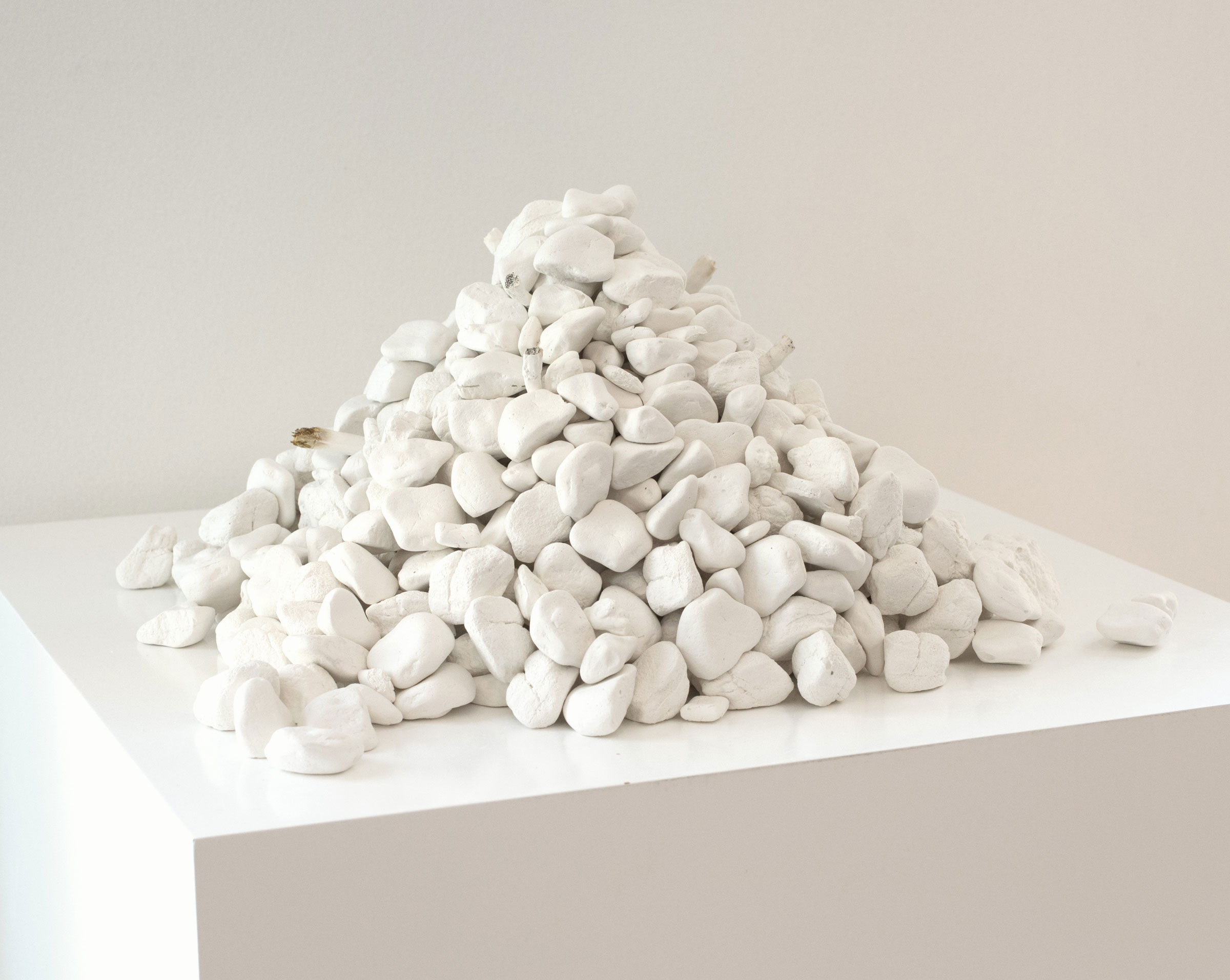Osiris's Teeth | 400 plaster cast rocks from Dead Sea, cast found cigarettes, cast gum | variable size