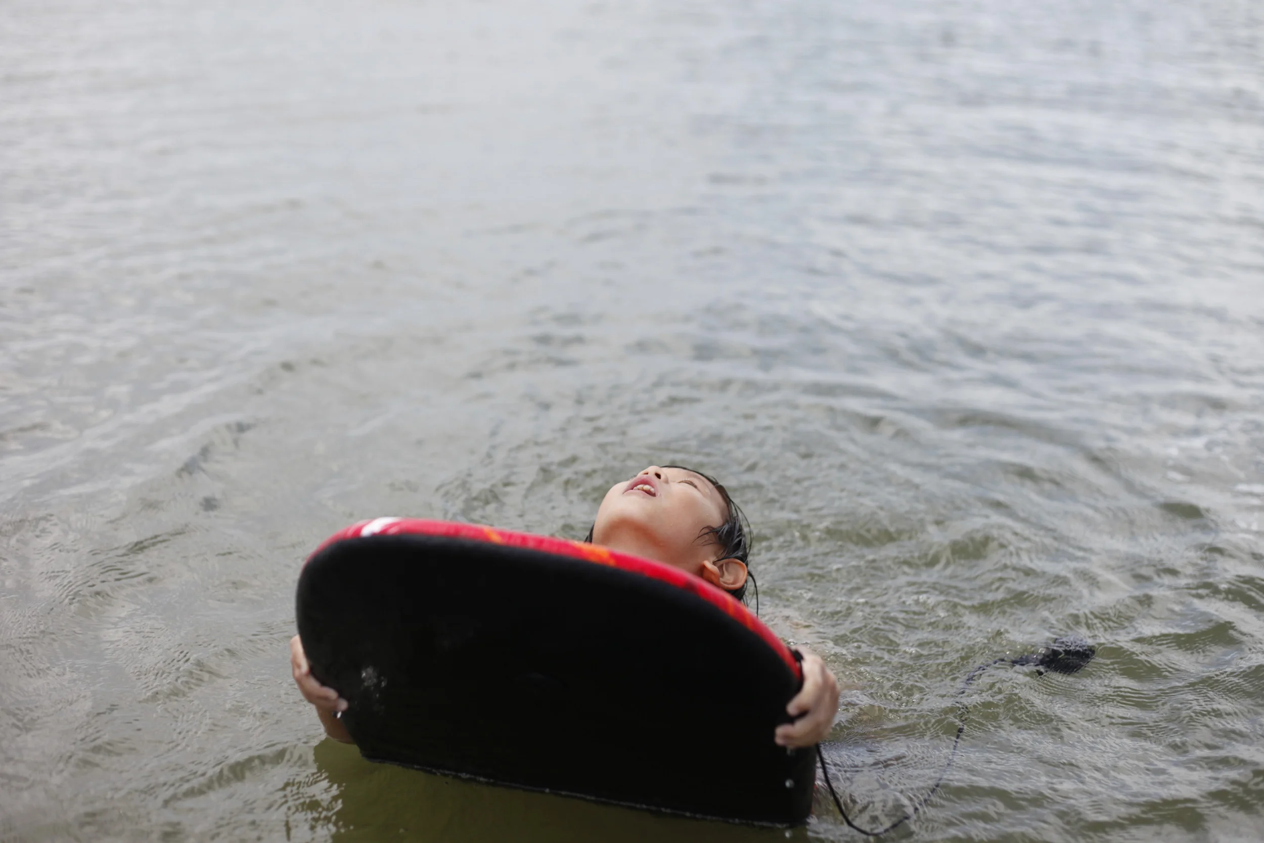 Theodore Lee uses a board to float.