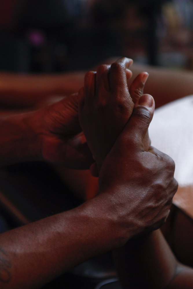 A husband holds on to his wife's hand as Richie covers up an old tattoo.
