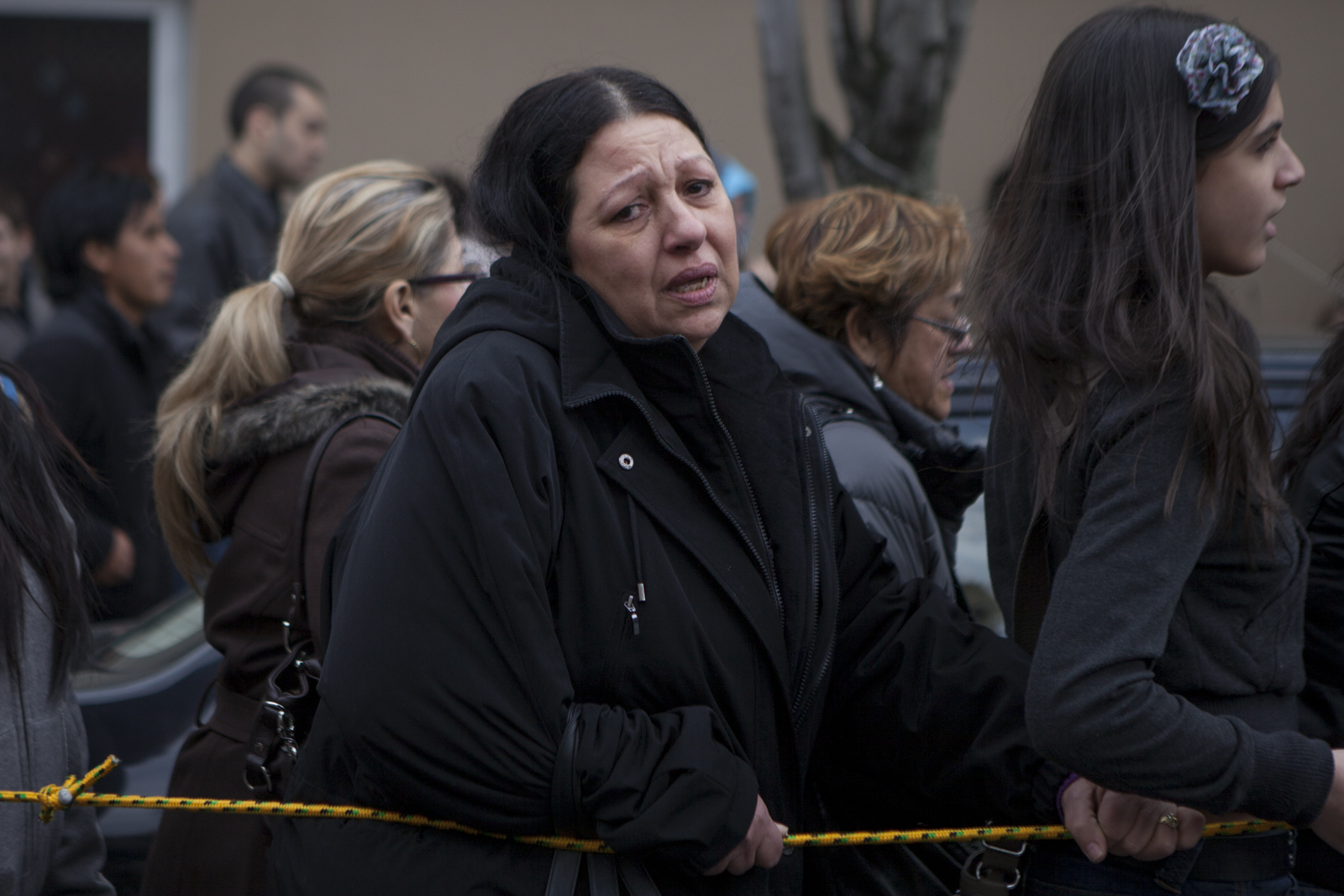 A woman marches alongside the stations.