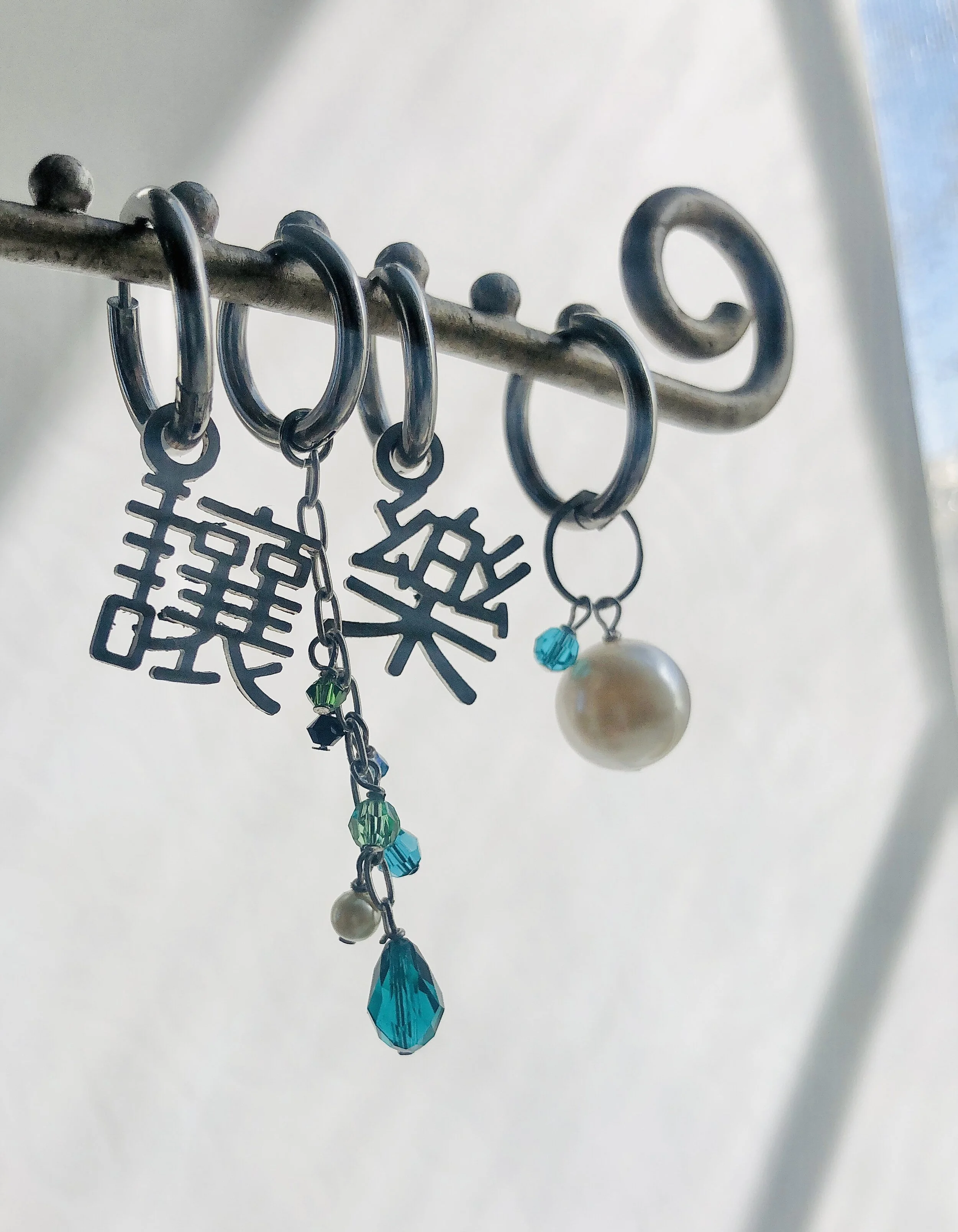 Mismatched earrings - one Kanji and one crystal dangle