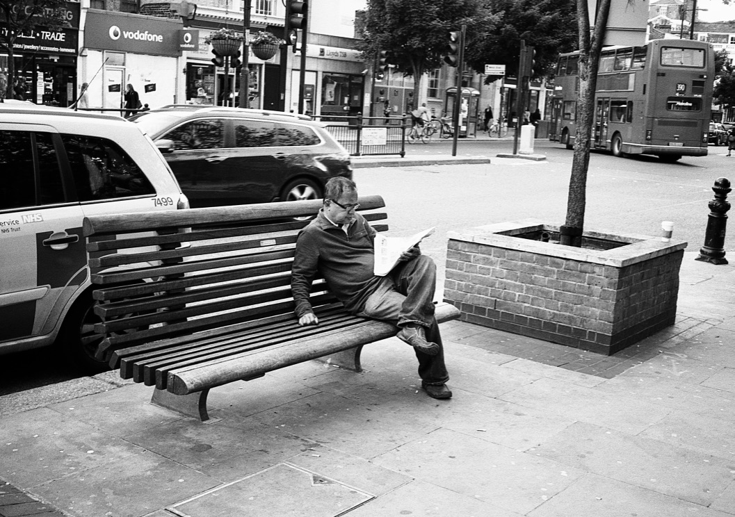 Reading 'out of home', Notting Hill Gate, London, England (Summer 2012) // Kodak T- Max 100, Zorki - 4, Epsom V330 // Sometimes you just need space that your home cannot provide for you. Sometimes you want noise. Sometimes you want to watch the people walk by or eaves drop on a conversation at the end of a newspaper. And sometimes the confines of your personal living space cannot fulfil all your needs. What better location than outside tube station? 