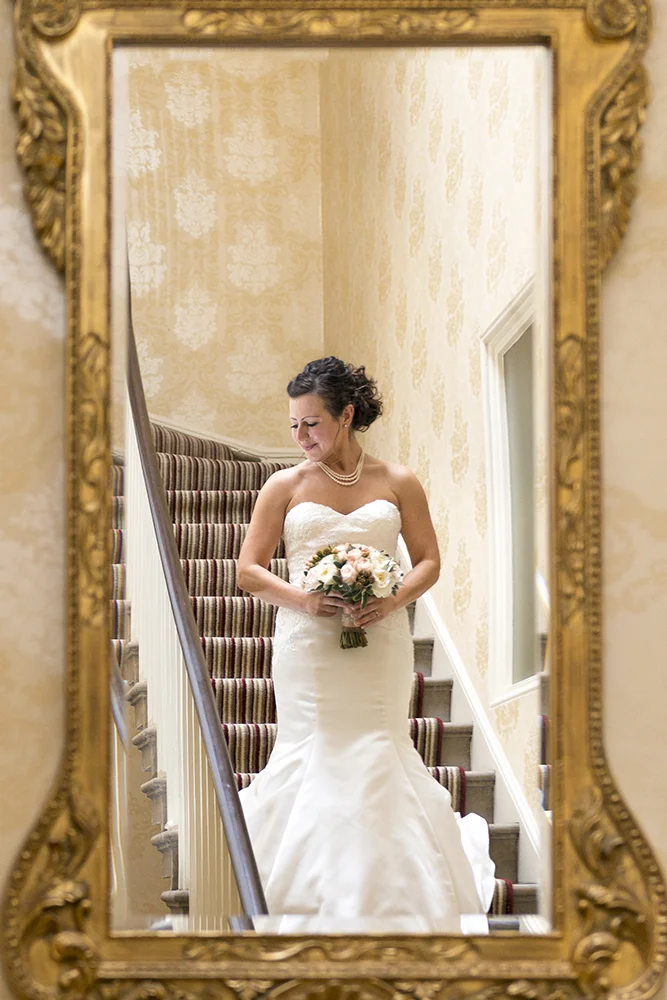 bride-descending-stairs-mirror-in-reverie.jpg