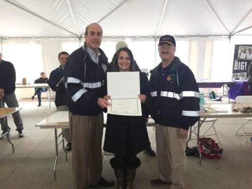 Laura LoBreglio of BBBS of FSW receives Westchester County’s Reuse and Recycle Award from Deputy County Executive Kevin Plunkett (L) and Department of Environmental Facilities Commissioner Thomas Lauro (R) at the Earth Day ceremonies May 13, 2017, at Kensico Dam.