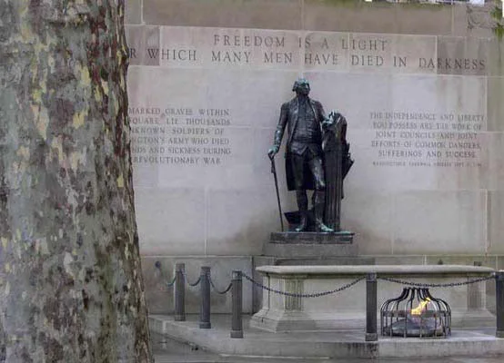Eternal flame honors thousands of soldiers, American and British, buried beneath the arching trees of Washington Square. Uncounted hundreds of yellow fever victims also lie here.