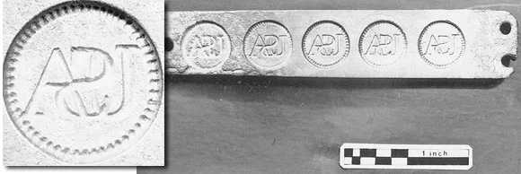Button mold marked "USA" (detail enlarged) was discovered in a large pit beneath New Hall. Other items: slag, musket flints, knives & forks, 17 links of iron chain, and four cannon balls, each weighing over five pounds.