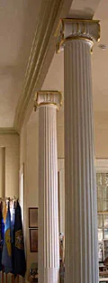 Decorative columns enclosed supporting timbers and replaced room partitions.