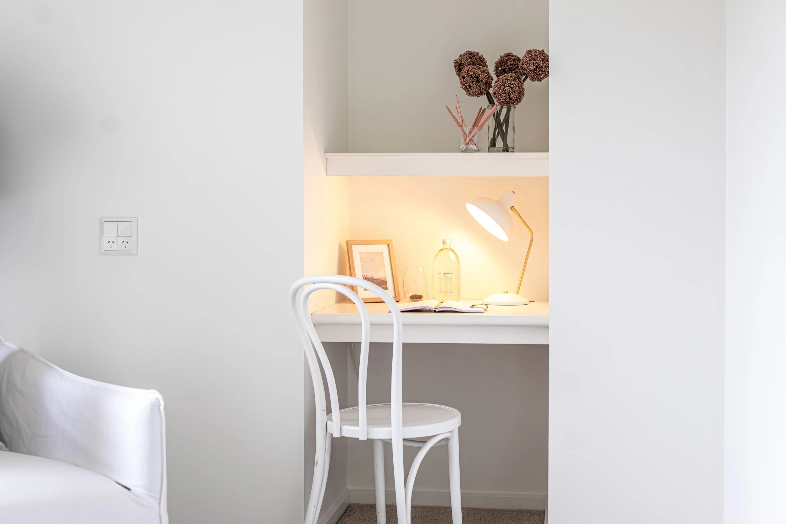 Fresh figs and salt and pepper grinders displayed elegantly on a timber kitchen bench
