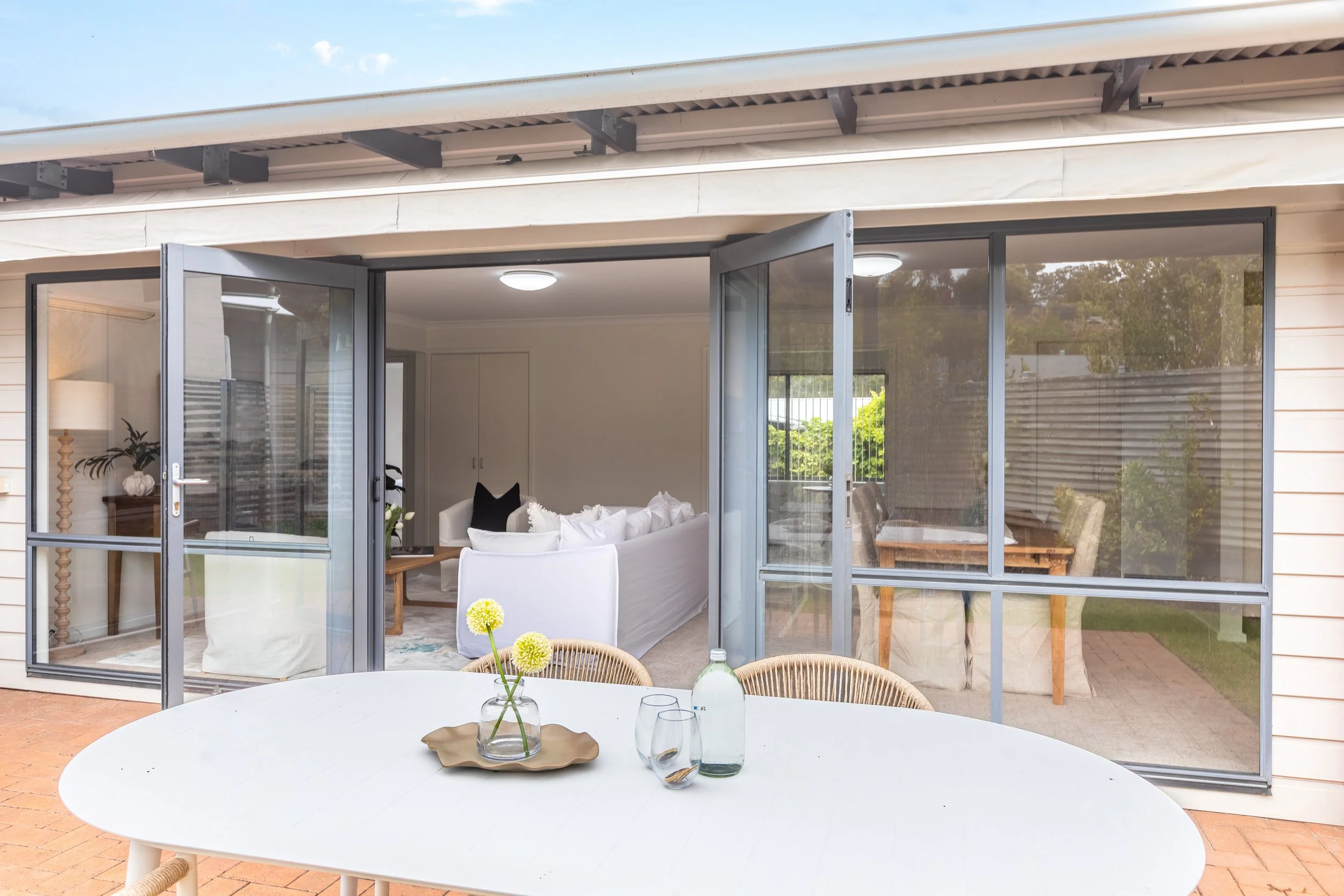 Fresh figs and salt and pepper grinders displayed elegantly on a timber dining table