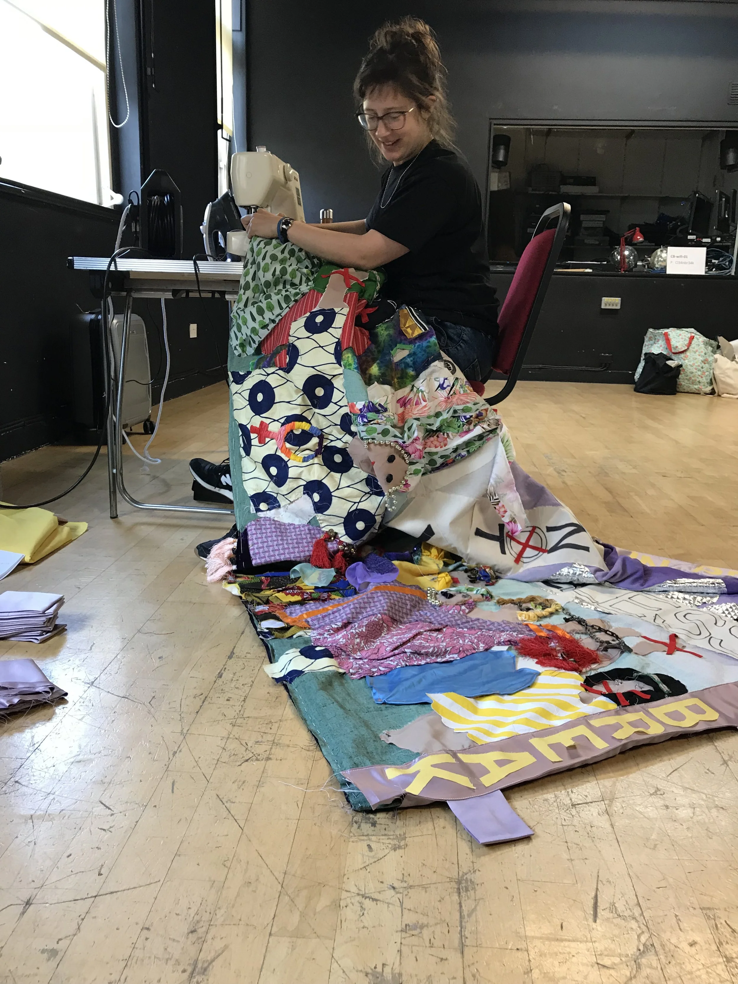  Sewing the borders onto the banner with artist Stella Cecil, who co facilitated the workshops, at Clean Break  Photo Miriam Nabarro 